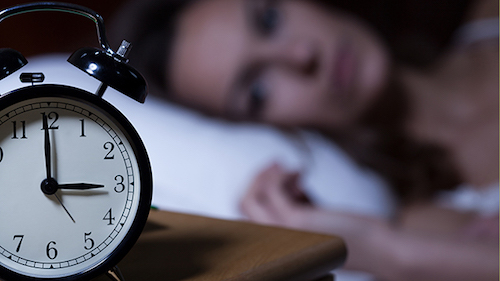 Close-up of alarm clock on night table